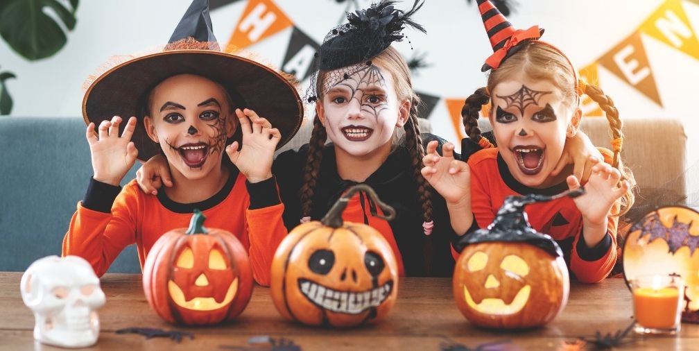 3 young girls in Halloween costumes 