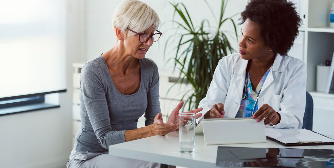 Older woman talking to a doctor 