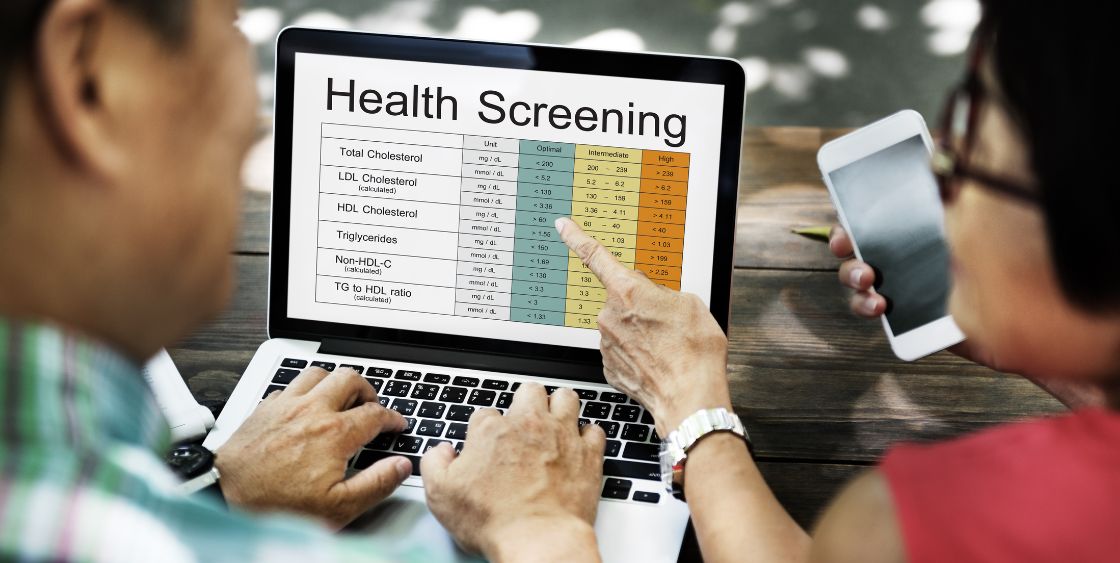 Computer screen with health screening on it. Man and women analyzing the screen. 