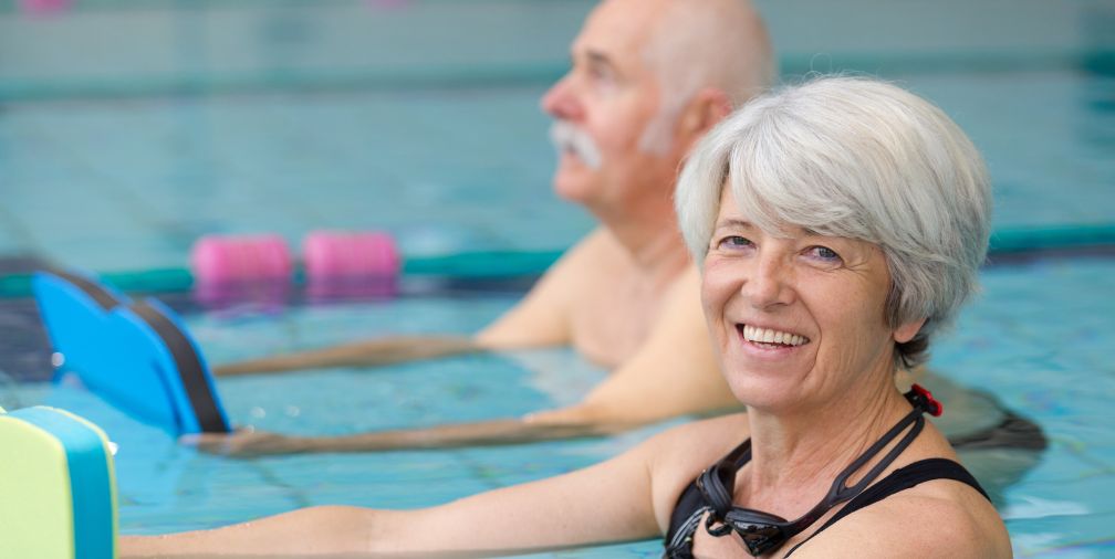 Older lady and man doing pool exercises 