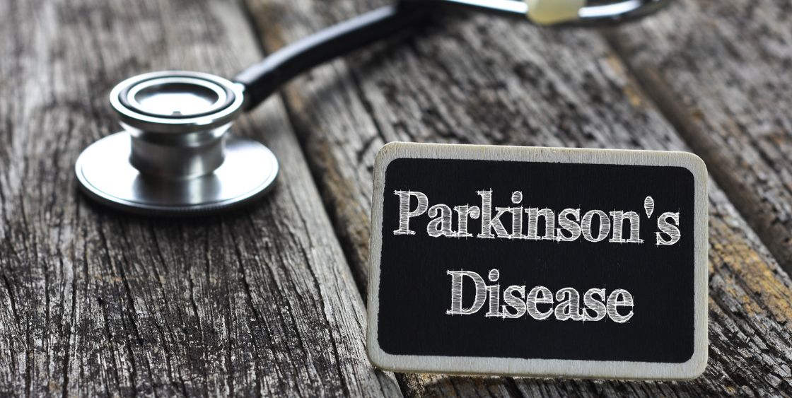 Stethoscope with a sign that says "Parkinson's Disease" 